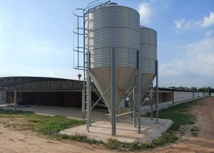 silver feed hopper on chicken farm
